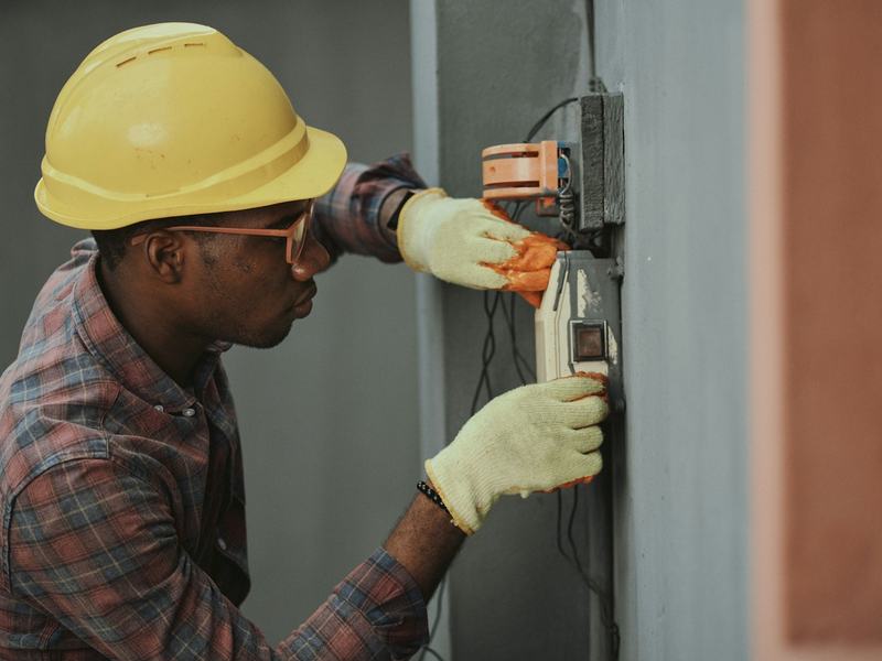 An electrician at work on a panel