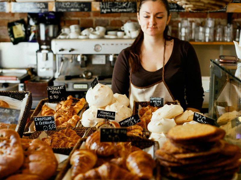 A bakery owner behind her counter